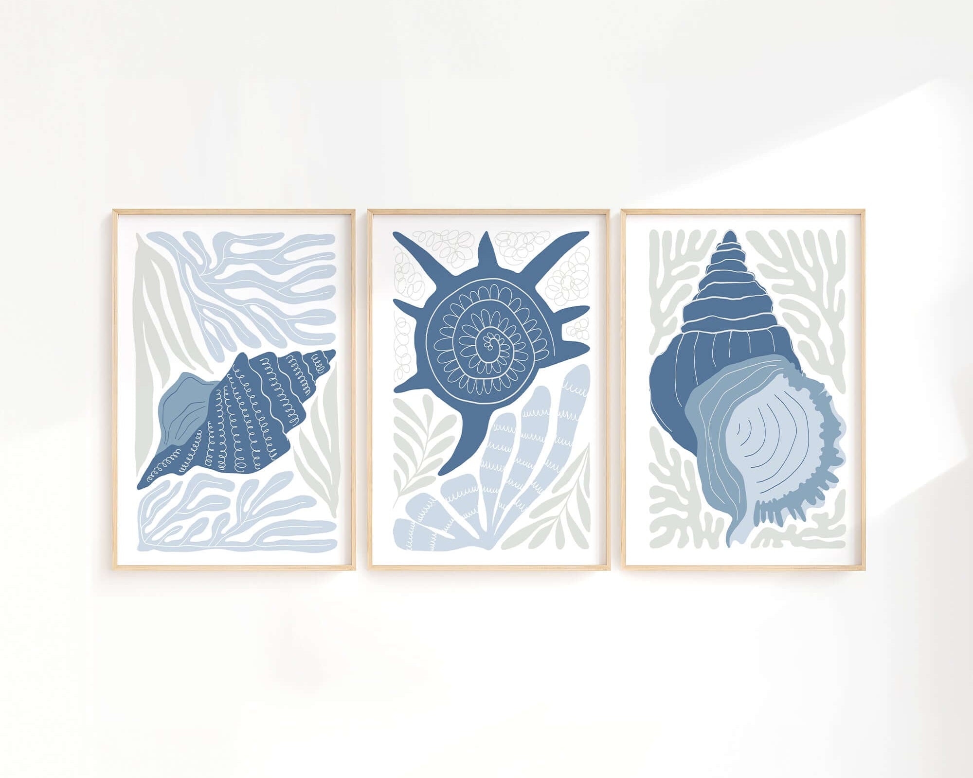 The Ocean Blocks Triptych | Set of Three Prints | 344 features framed abstract seashell illustrations in blue tones, offering modern and stylish wall art to enhance your home decor.