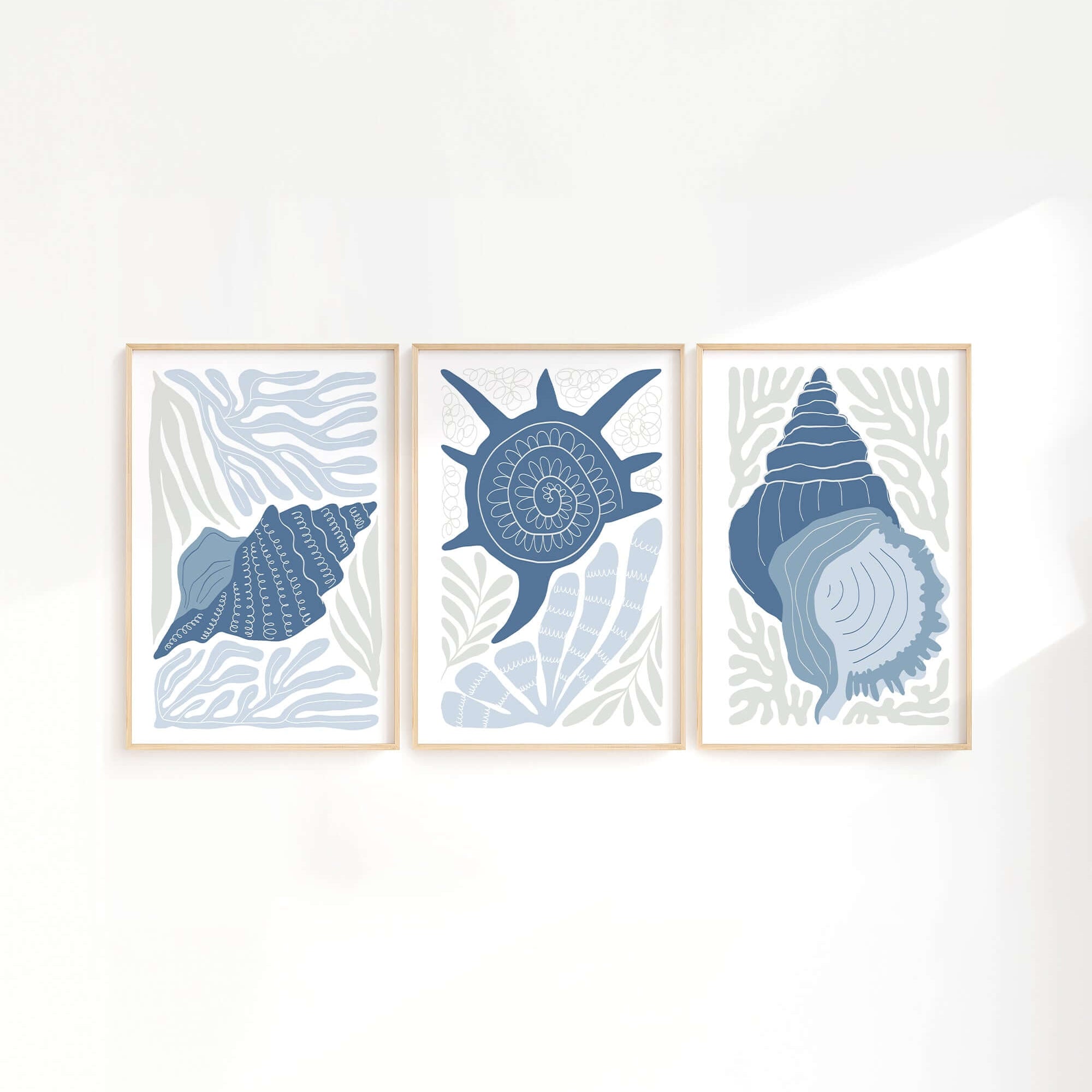 The Ocean Blocks Triptych | Set of Three Prints | 344 features framed abstract seashell illustrations in blue tones, offering modern and stylish wall art to enhance your home decor.