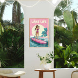 a poster of a woman paddleboarding on a tropical beach, with palm trees and a pink and yellow background. The poster is hanging on a wall, and there is a small table with a vase of flowers in front of it.