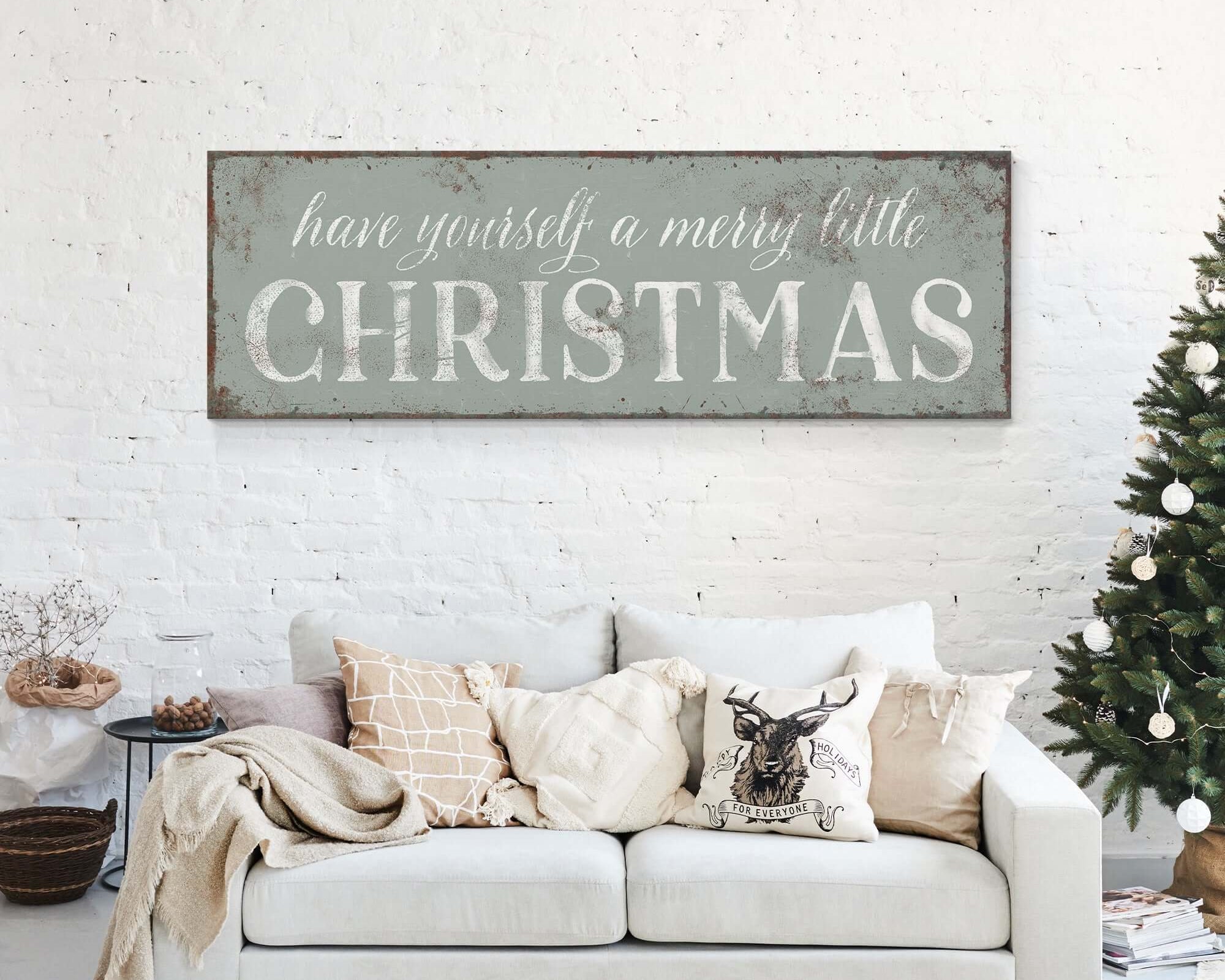a white couch sitting in a living room next to a christmas tree
