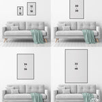 Four gray sofas with green throws, each beneath vertical rectangular frames on white walls, create an ideal backdrop for the Beach House Rules Sign, a painted wood nautical wall accent perfect for beach house decor.