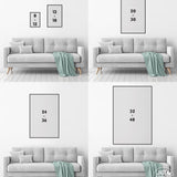 Four gray sofas with green throws, each beneath vertical rectangular frames on white walls, create an ideal backdrop for the Beach House Rules Sign, a painted wood nautical wall accent perfect for beach house decor.