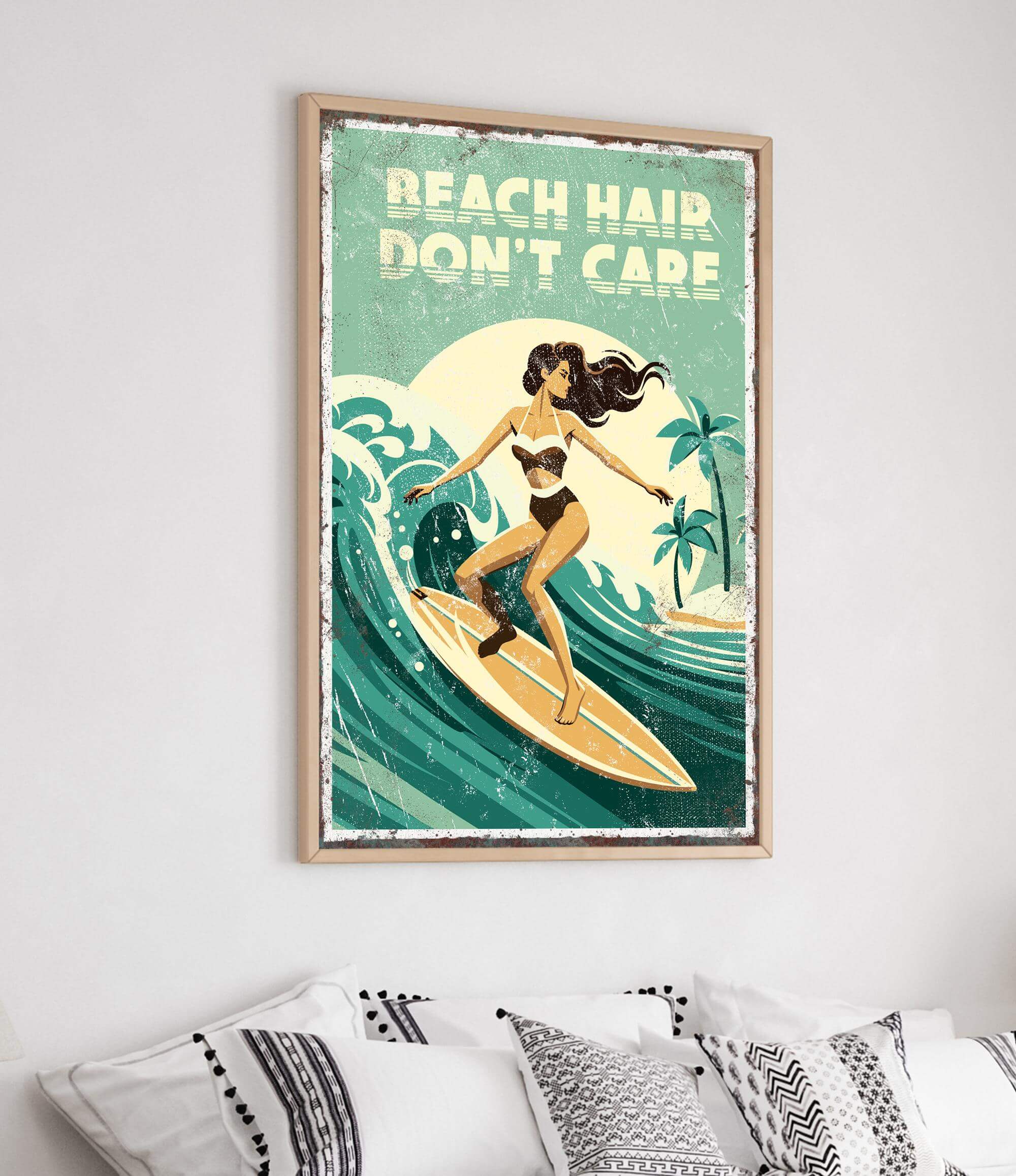 a framed poster with a woman surfing on a wave, with the text "BEACH HAIR DON'T CARE" written above her.