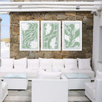 a living room filled with white furniture and a stone wall