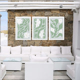 a living room filled with white furniture and a stone wall