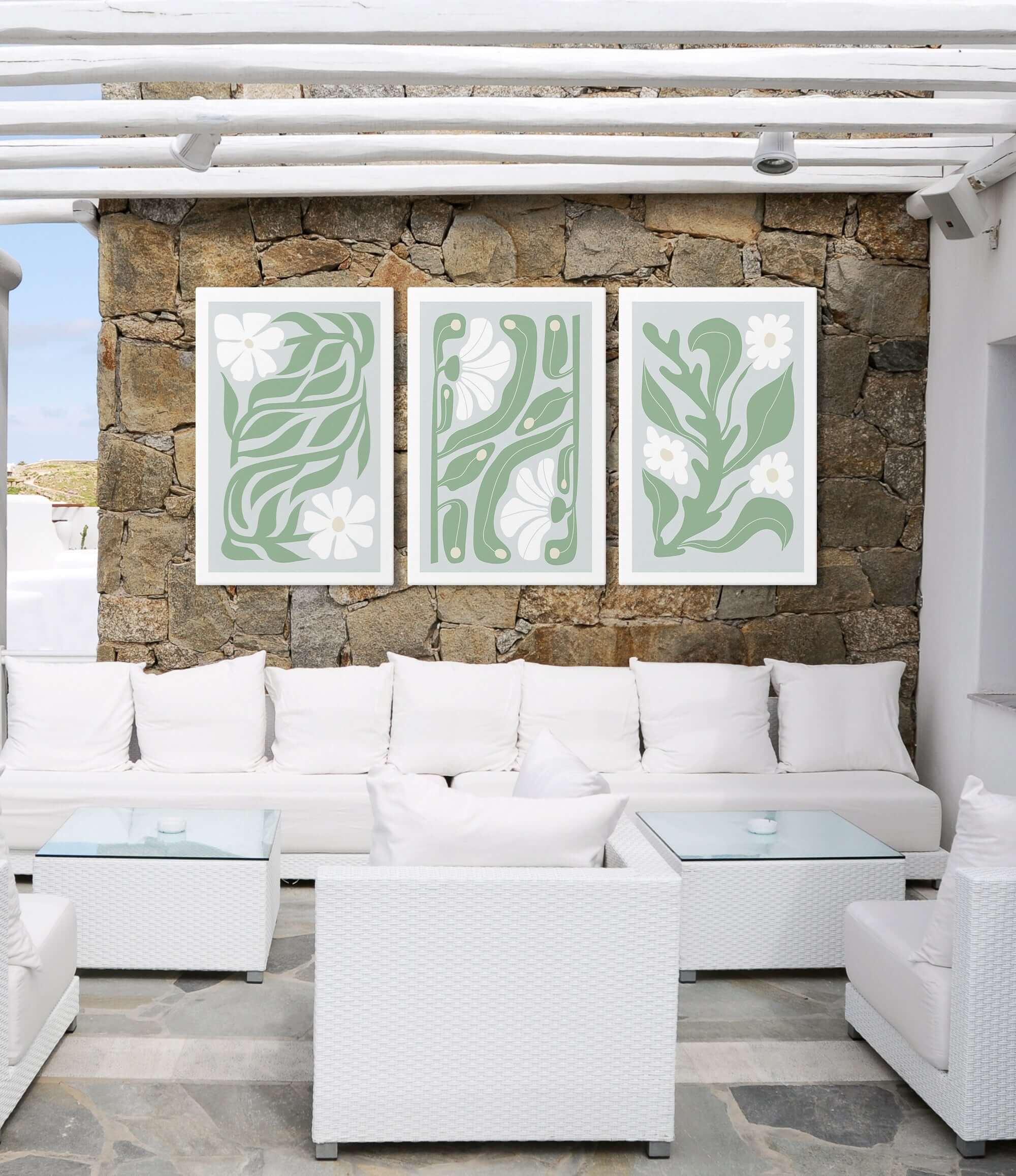 a living room filled with white furniture and a stone wall