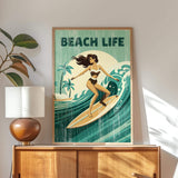 a framed poster of a woman surfing on a wave, with the text "BEACH LIFE" prominently displayed.