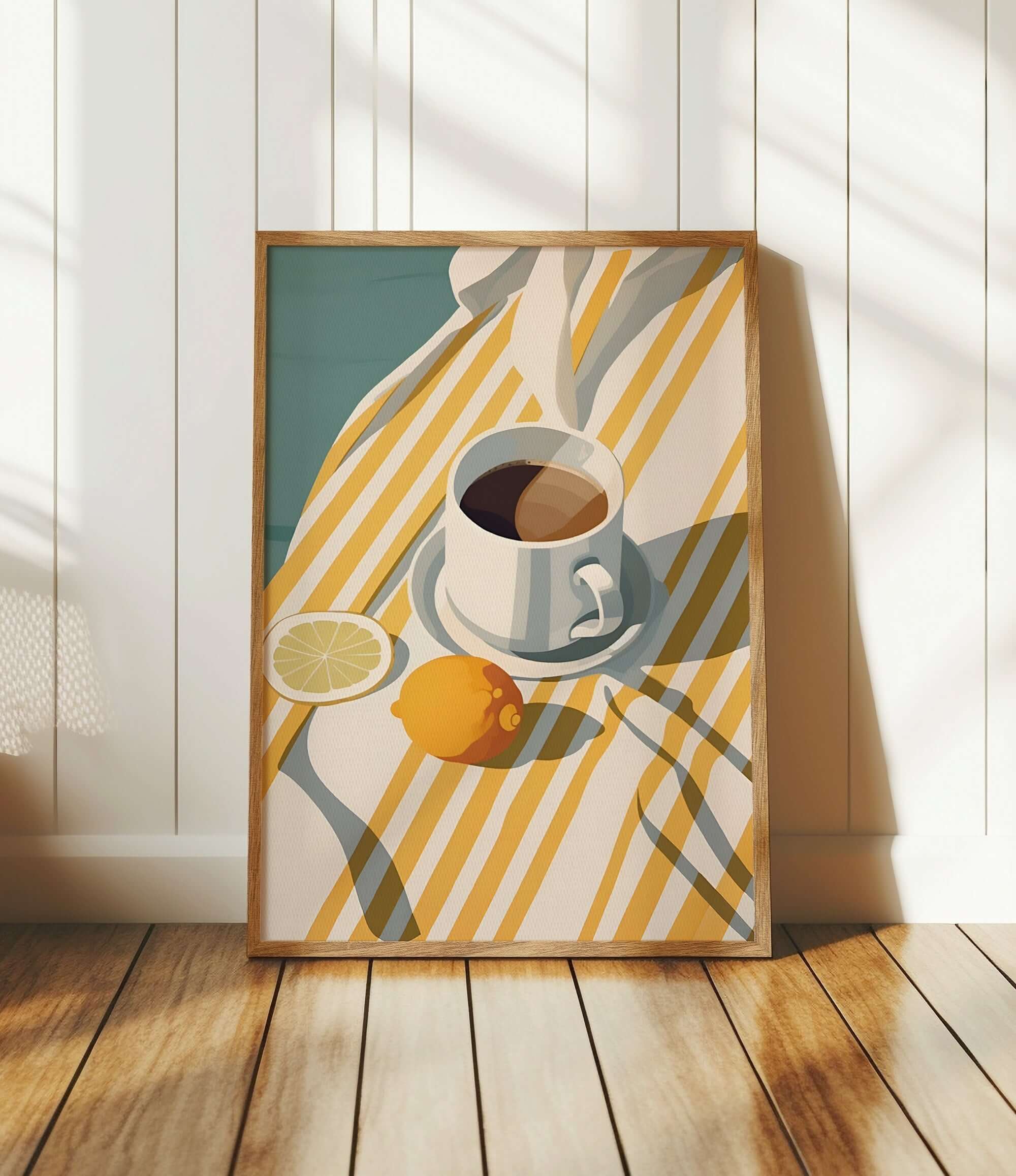 A framed illustration of a cup of coffee, a lemon slice, and a striped cloth on a wooden floor.