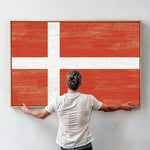 a man standing in front of a large flag
