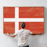 a man standing in front of a large flag
