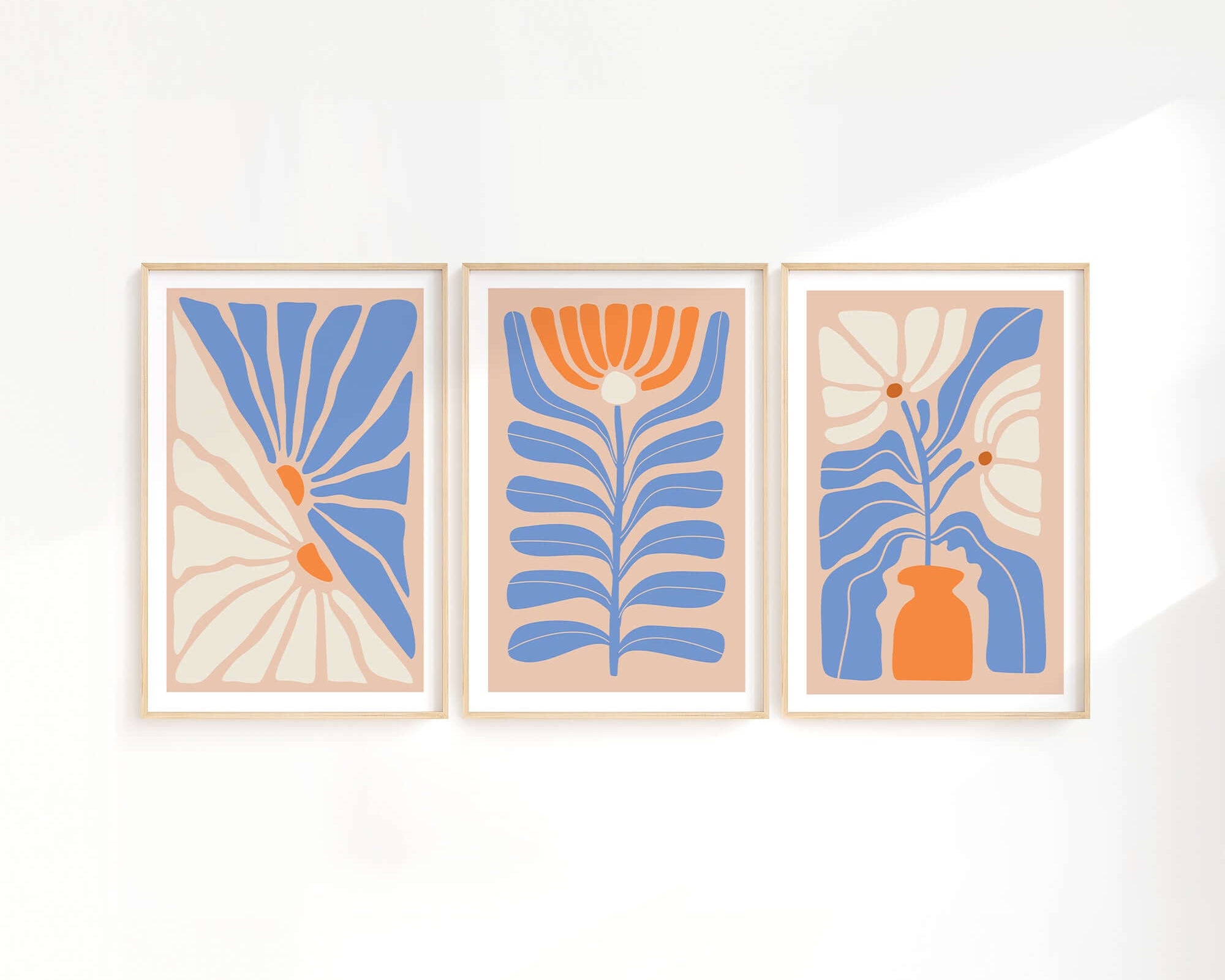 The Flower Blocks Triptych | Set of Three Prints | 010 features blue, orange, and beige floral and botanical designs—perfect wall art to elevate your home decor on a crisp white wall.