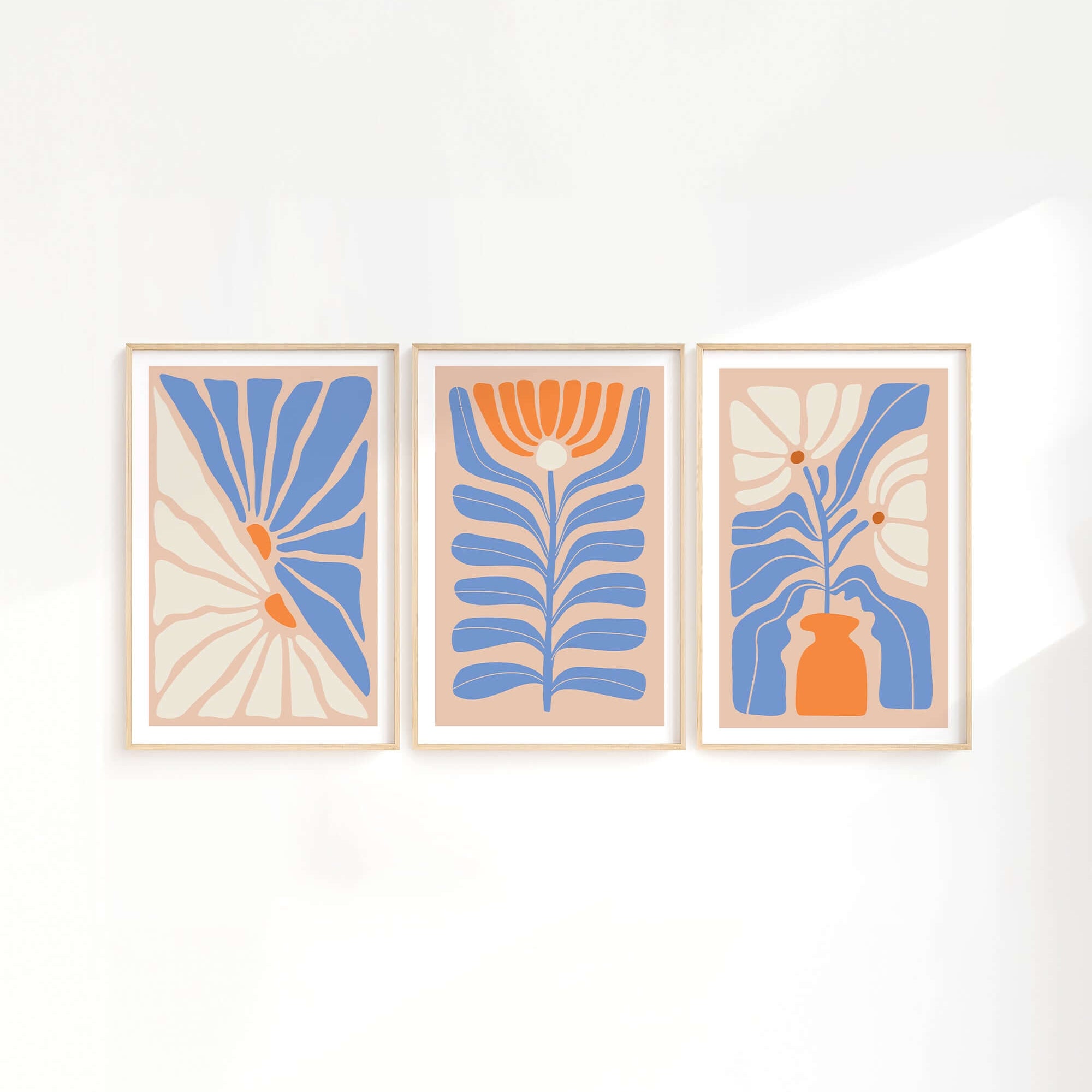 The Flower Blocks Triptych | Set of Three Prints | 010 features blue, orange, and beige floral and botanical designs—perfect wall art to elevate your home decor on a crisp white wall.