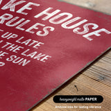 The image is a close-up of a red sign with white text, placed on a wooden surface.