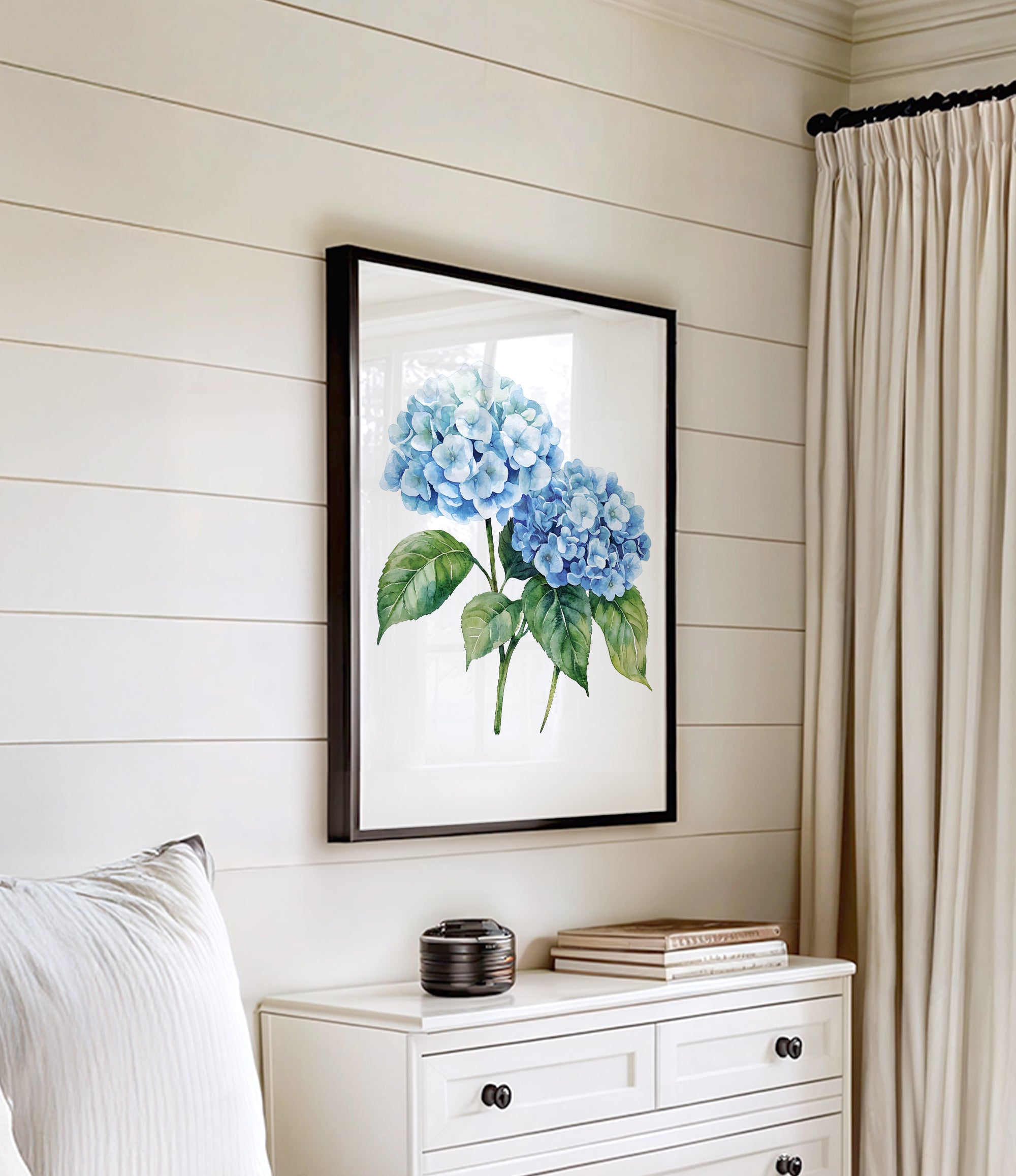 a white dresser with a framed picture of blue hydrangeas hanging on the wall above it.