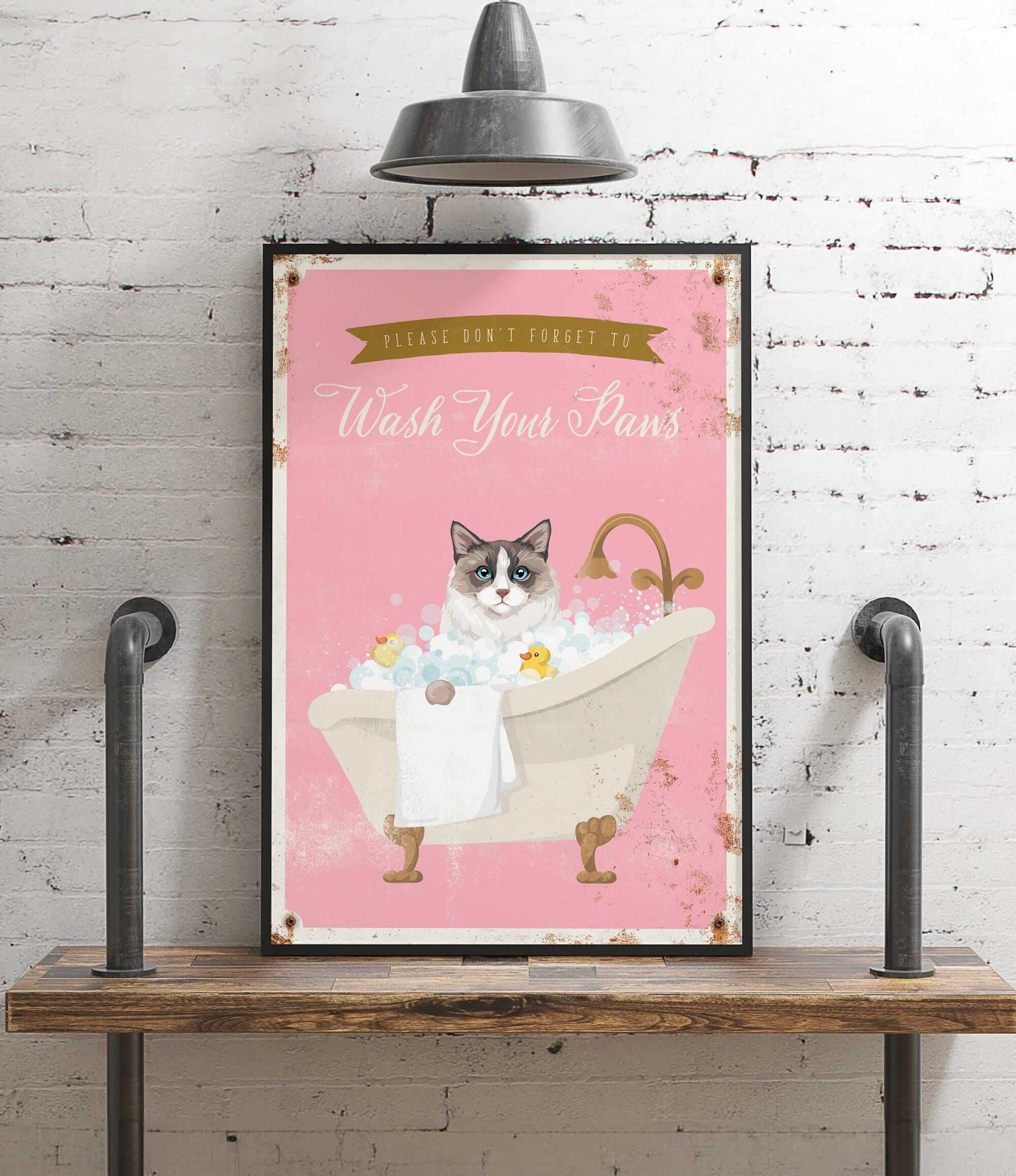 A framed poster with a cat sitting in a bathtub filled with bubbles, accompanied by the text "Please don't forget to wash your paws".
