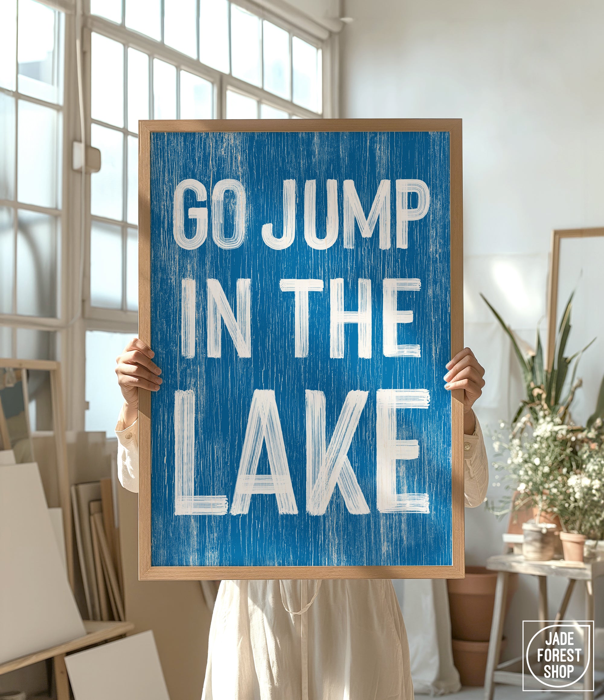 a person holding a sign that says go jump in the lake