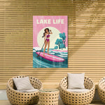 a woman paddleboarding on a surfboard, with a sign above her that says "LAKELife".