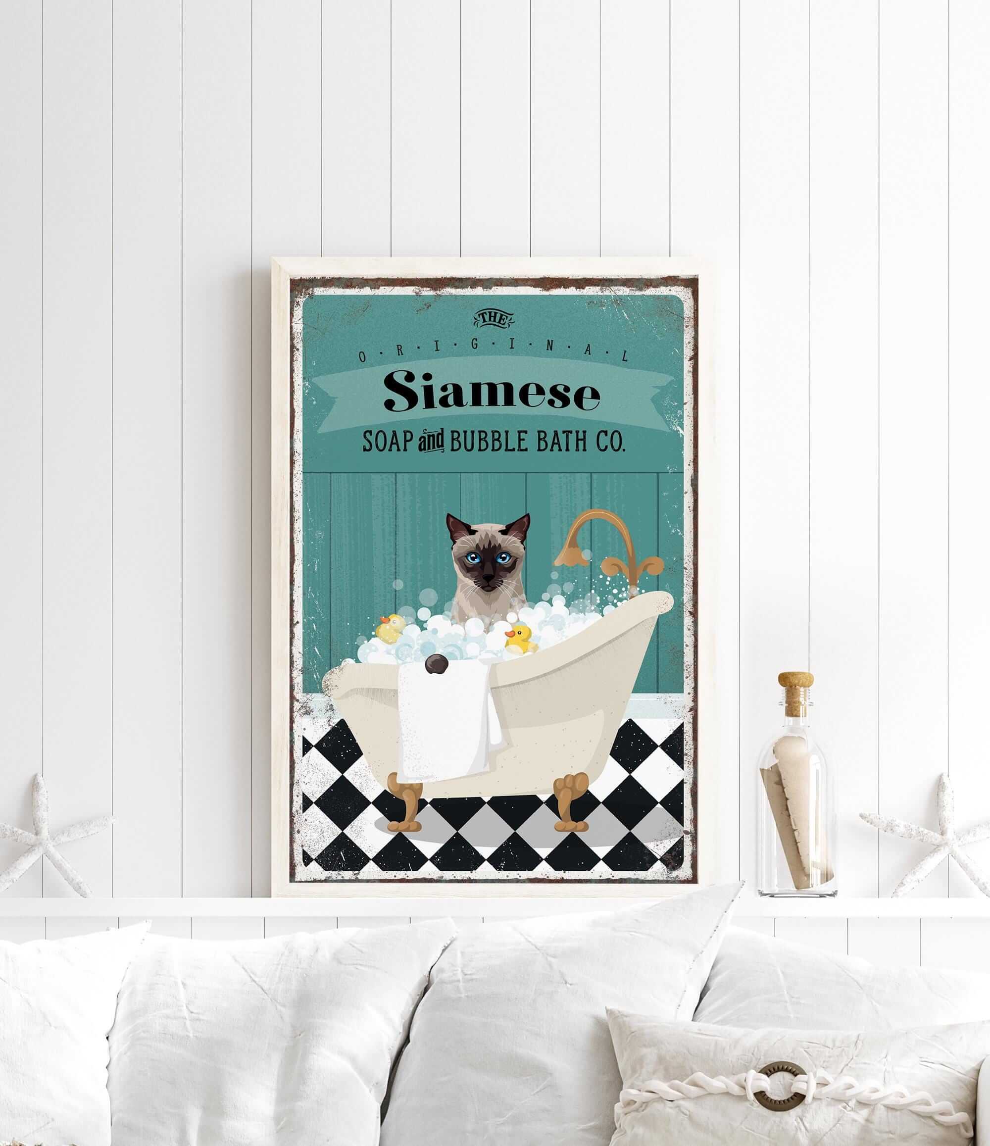 A framed poster of a Siamese cat sitting in a bathtub filled with bubbles, with a vintage-style design.