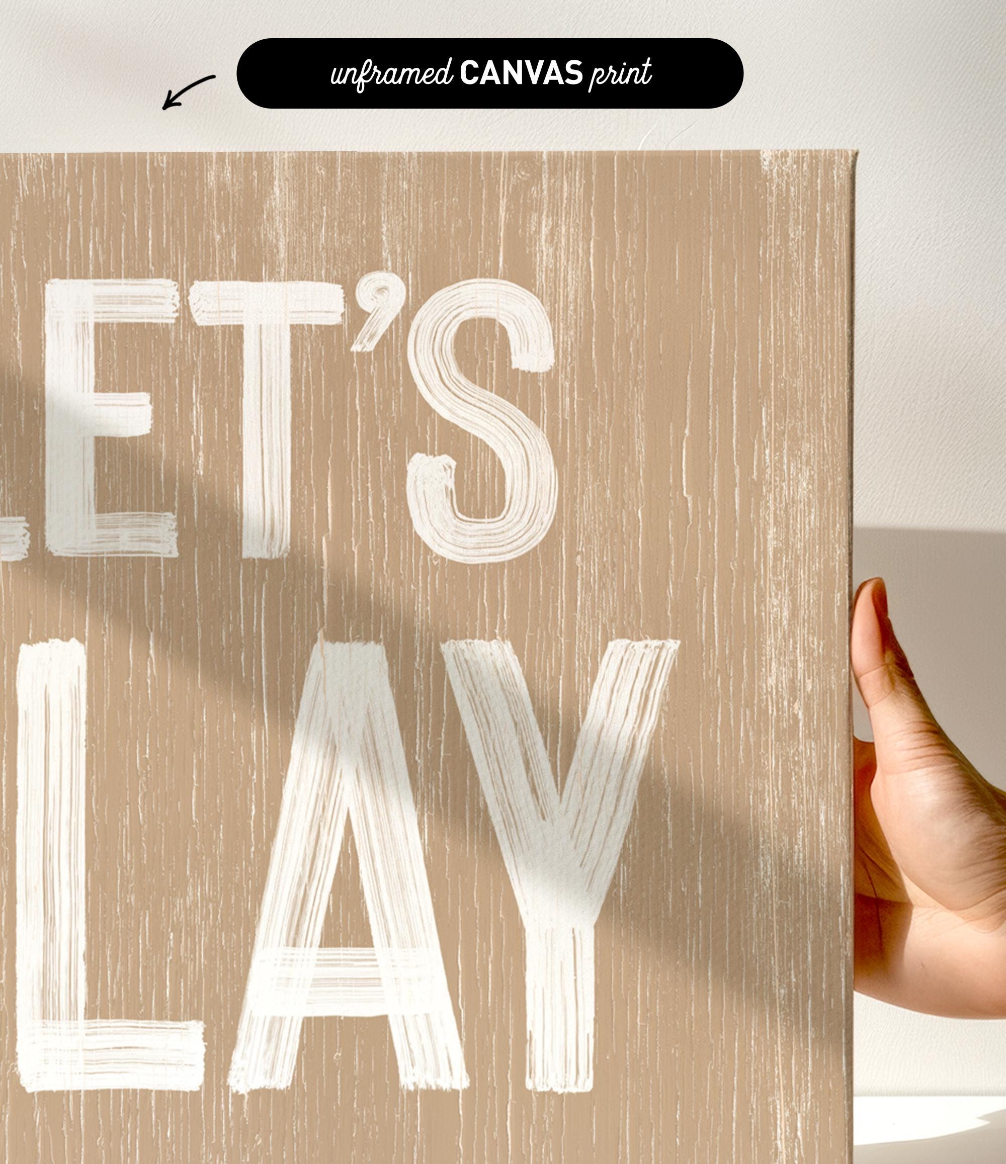 a hand holding a sign that says let&#39;s play