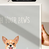 a hand holding a white canvas print with a dog illustration on it.