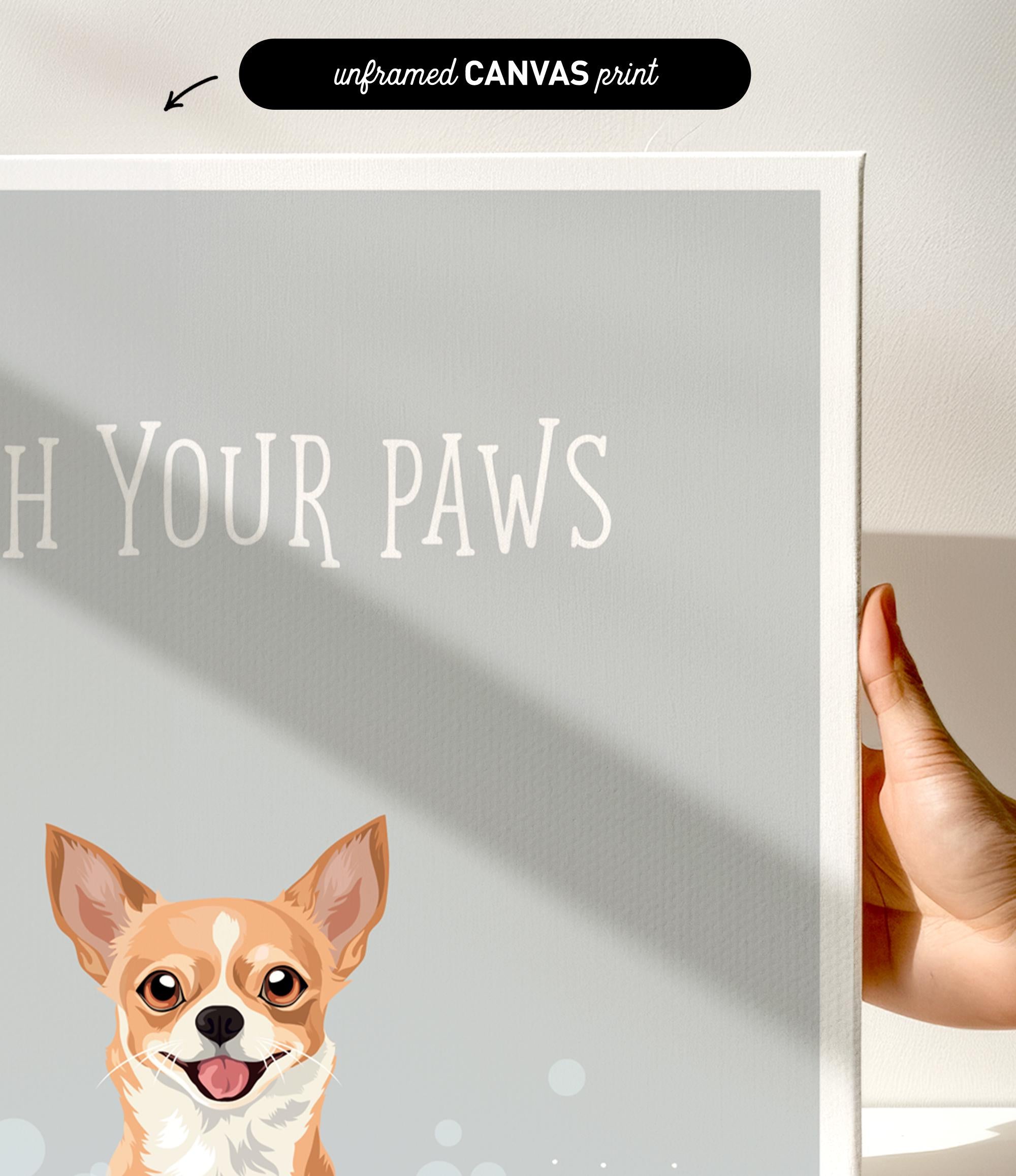 a hand holding a white canvas print with a dog illustration on it.