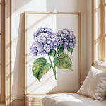 a large framed painting of purple hydrangeas on a wall, with a wooden frame and a white background.