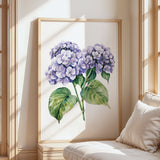 a large framed painting of purple hydrangeas on a wall, with a wooden frame and a white background.