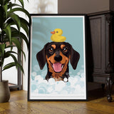 A framed illustration of a dog with a yellow rubber duck on its head, surrounded by bubbles, is displayed on a wooden floor.