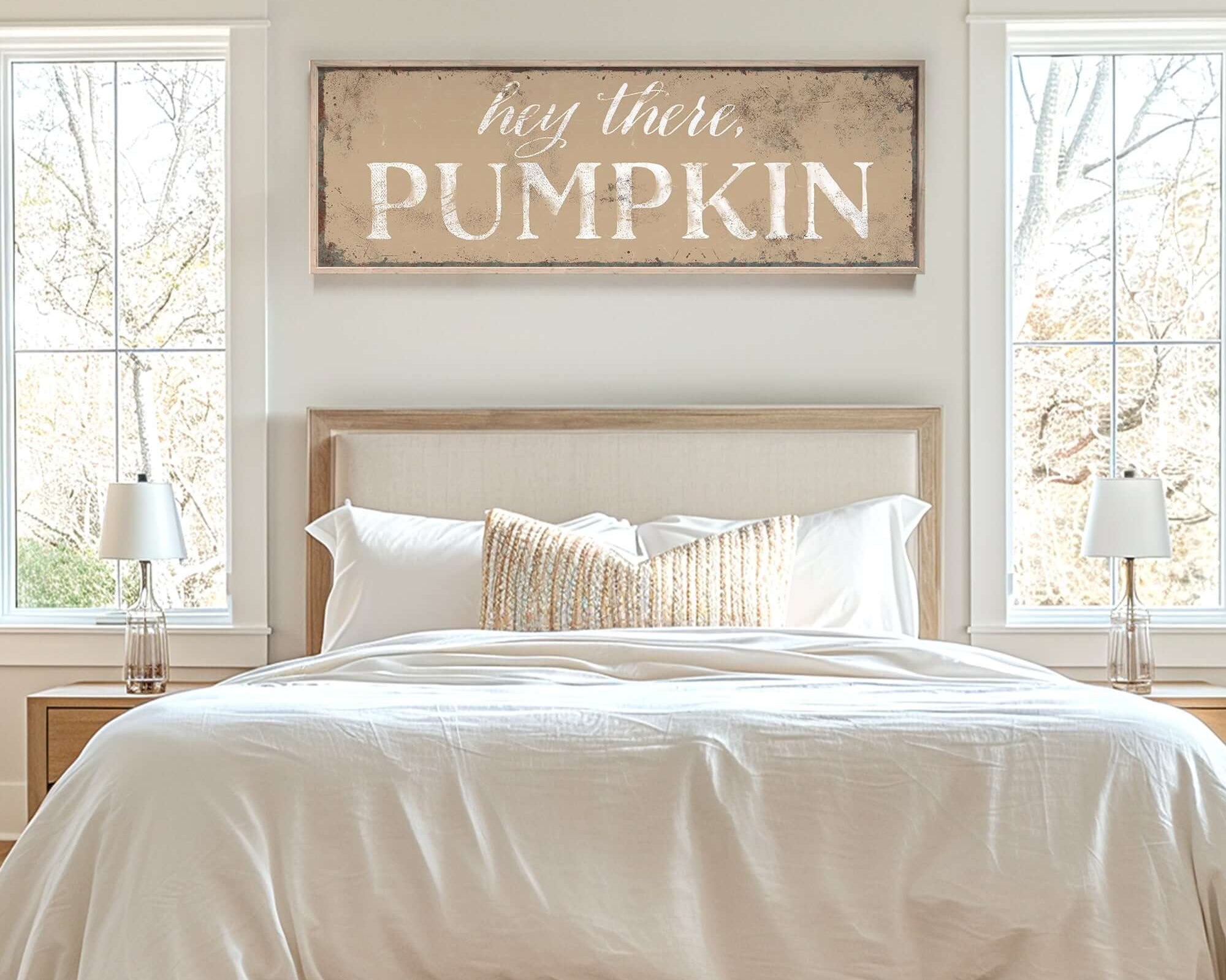 a bed with a white comforter and pillows