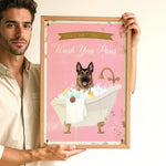 A man is holding a framed poster with a dog sitting in a bathtub filled with bubbles.