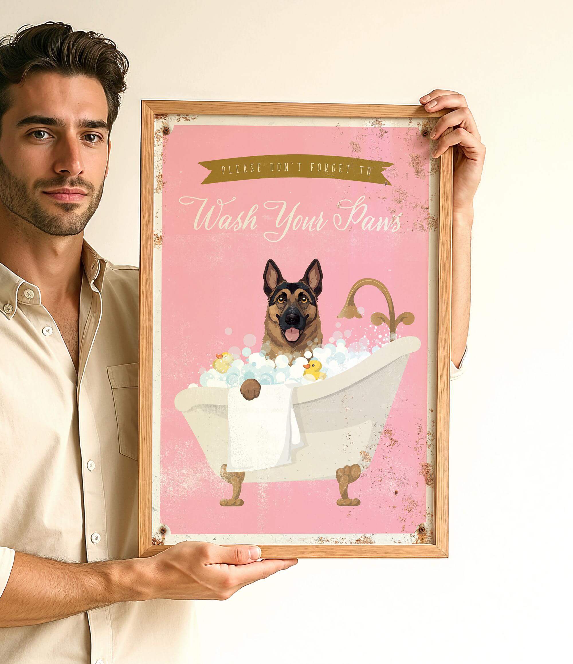 A man is holding a framed poster with a dog sitting in a bathtub filled with bubbles.