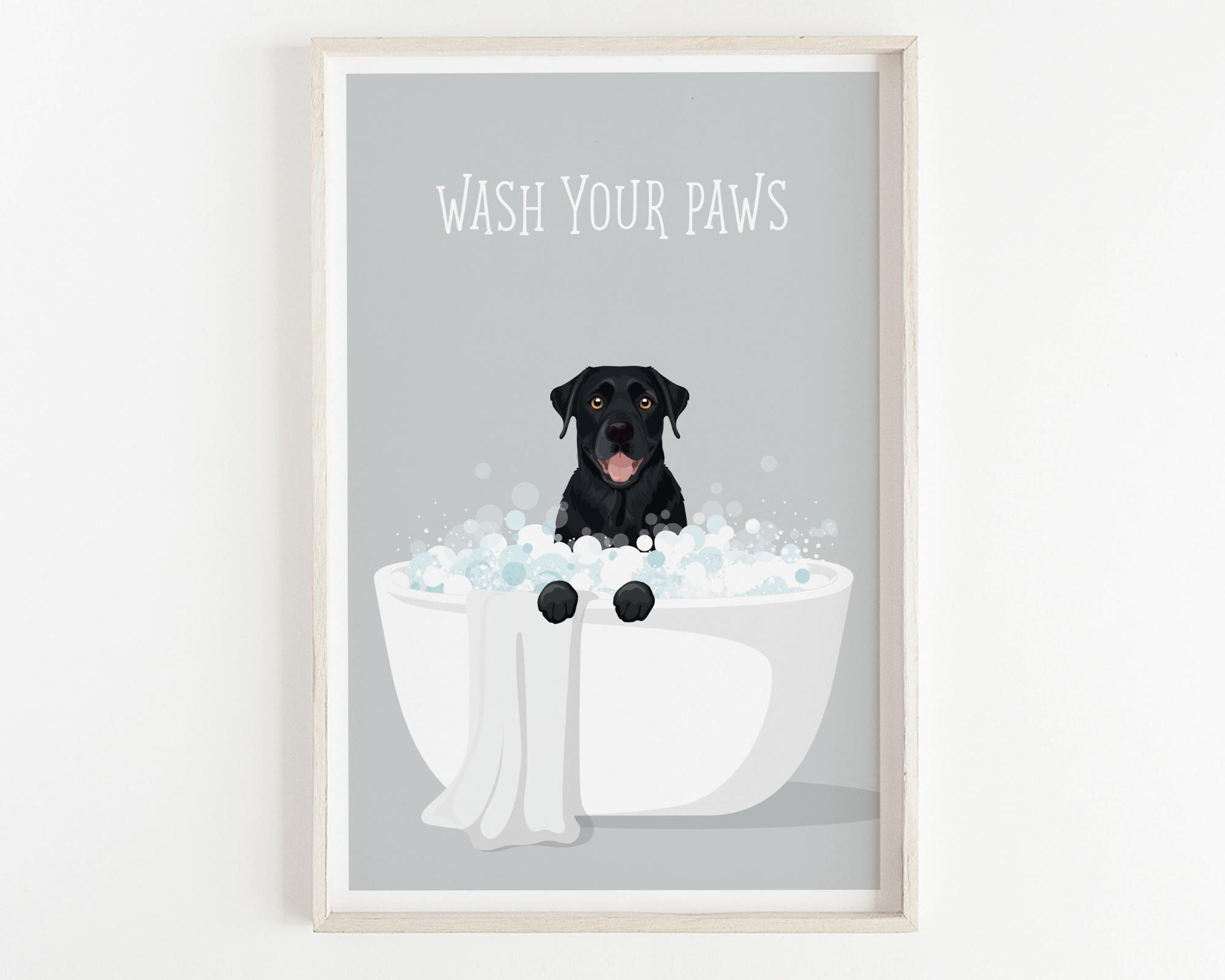 A framed illustration of a black dog sitting in a white bathtub filled with bubbles, with the text "WASH YOUR PAWS" displayed above it.