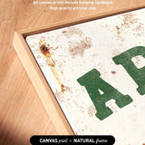 a close-up view of a canvas print with a rustic, aged appearance, and the word "AP" prominently displayed in the center.