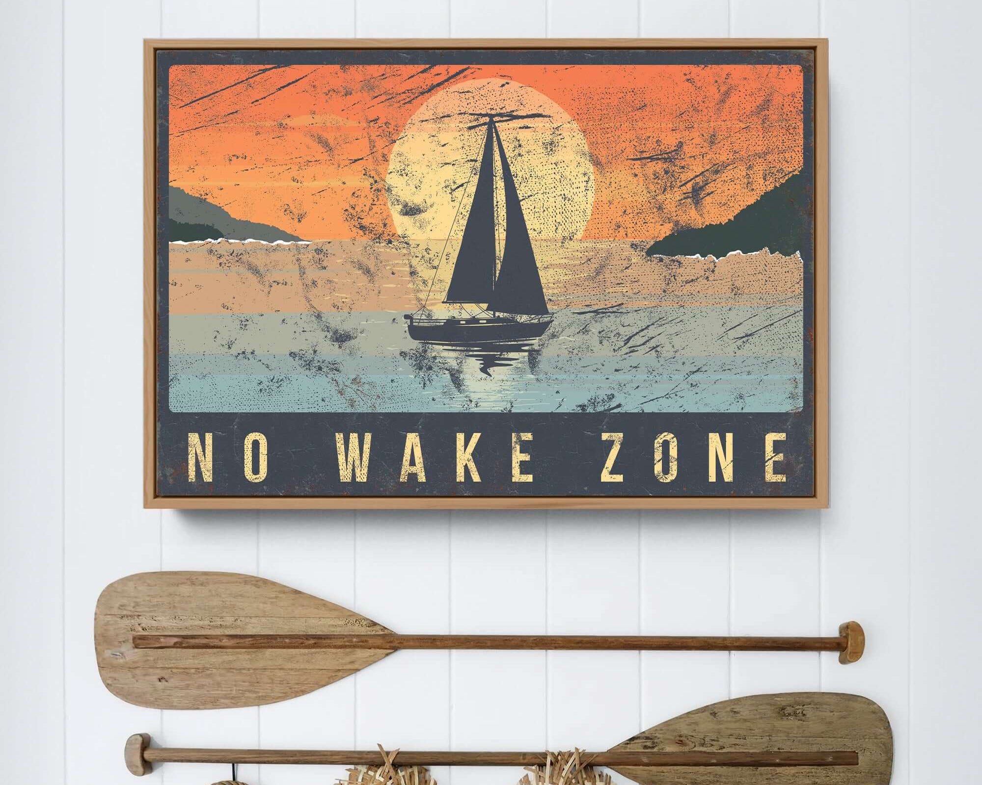 a picture of a sailboat and two paddles hanging on a wall