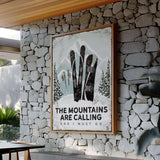 a stone wall with a sign that says the mountains are calling