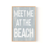 a wooden sign that says meet me at the beach