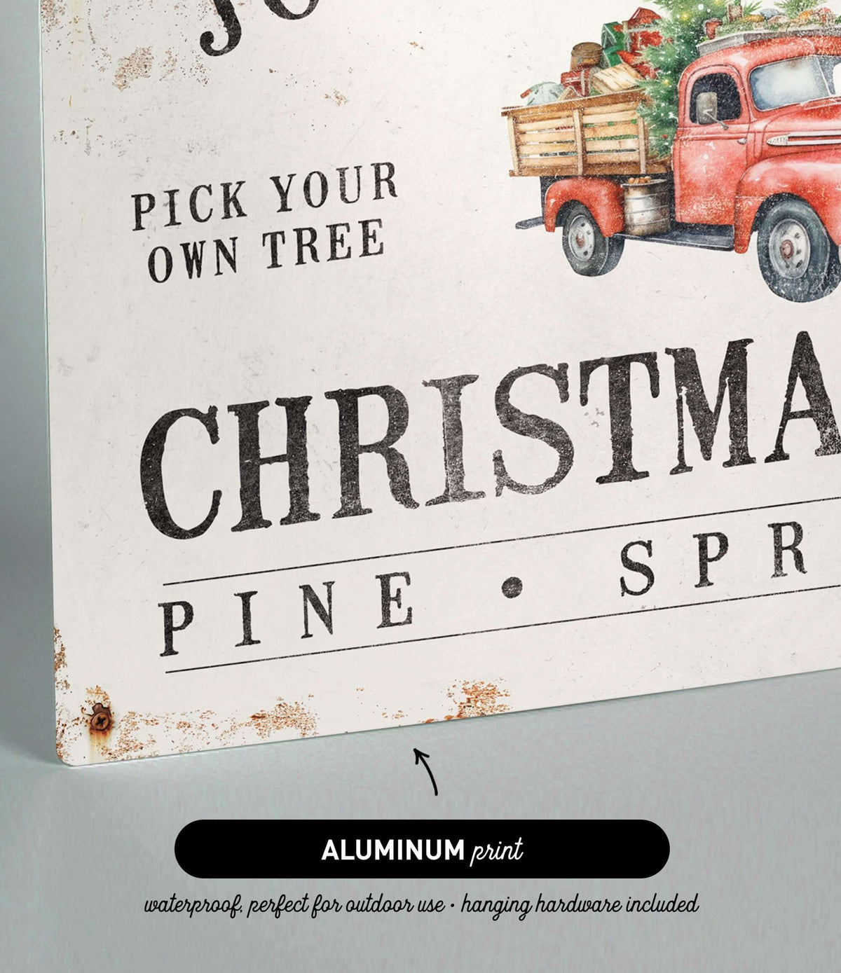 a christmas sign with a red truck carrying a christmas tree