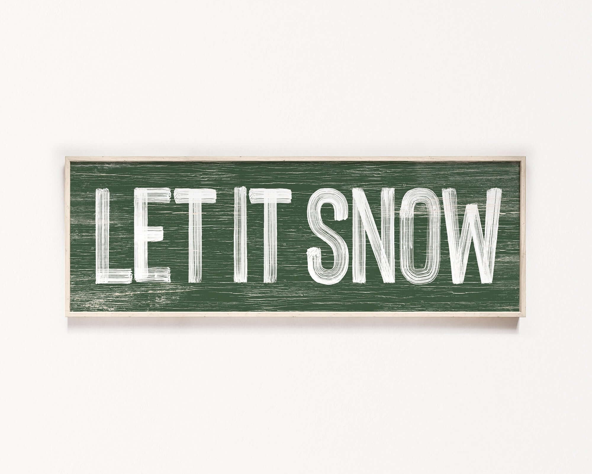 a wooden sign that says let it snow