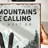 a hand holding a sign that says mountains are calling