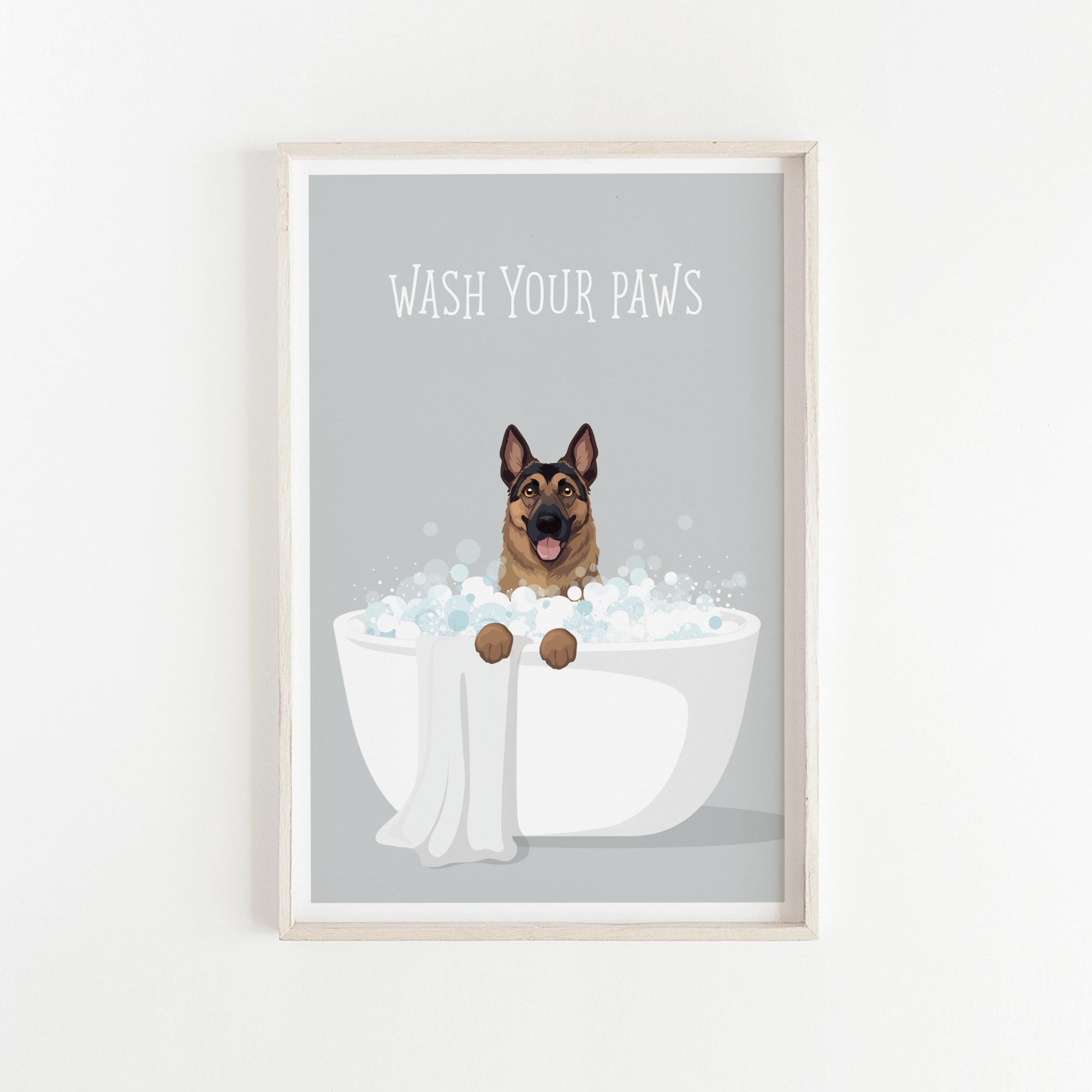 A framed illustration of a German Shepherd dog sitting in a white bathtub filled with bubbles, with the text "WASH YOUR PAWS" displayed above it.