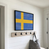 a wooden bench with a coat rack and a bag on it