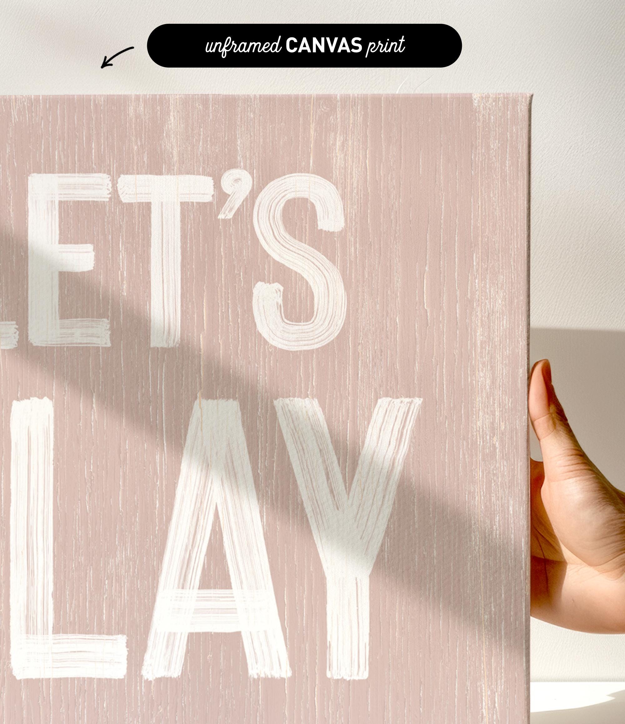 a person holding a sign that says let&#39;s play