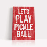 a red sign that says let's play pickle ball