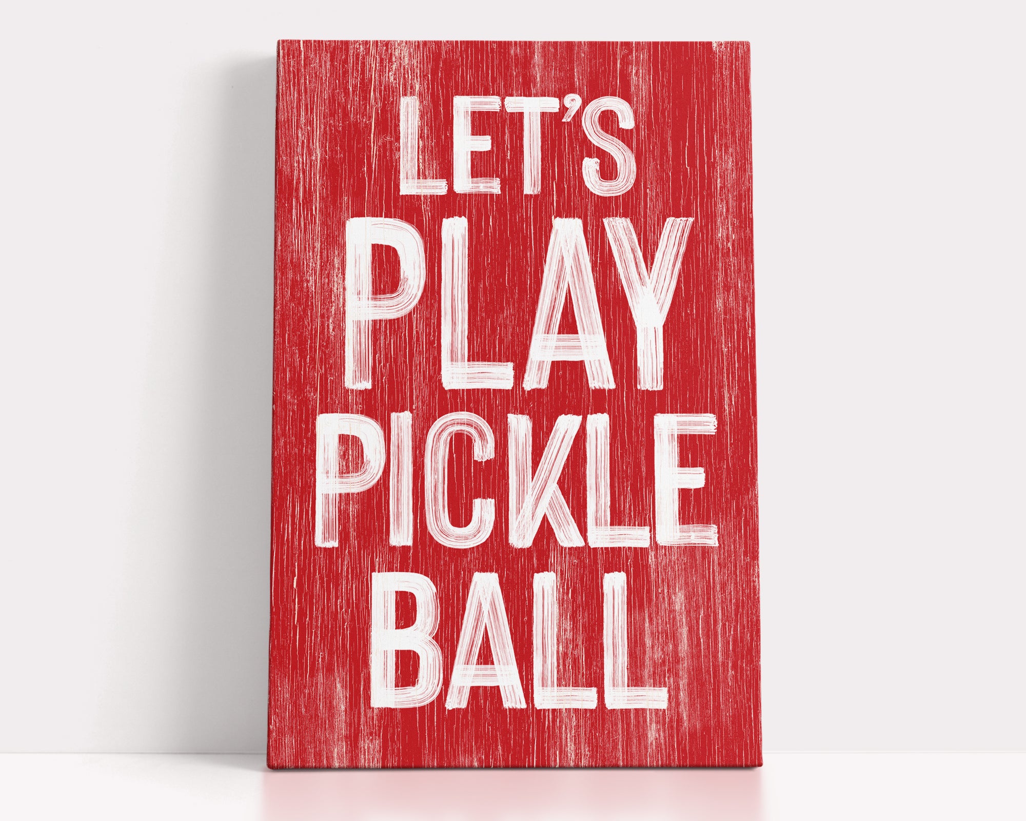a red sign that says let's play pickle ball