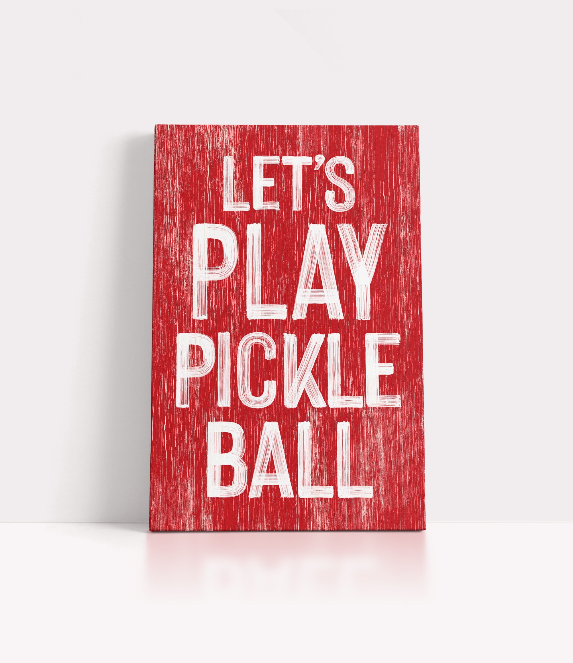 a red sign that says let's play pickle ball