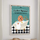 A framed poster of a Cocker Spaniel dog sitting in a bathtub filled with bubbles, surrounded by a checkered floor and a towel.