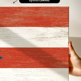 a hand holding a piece of wood with a flag painted on it