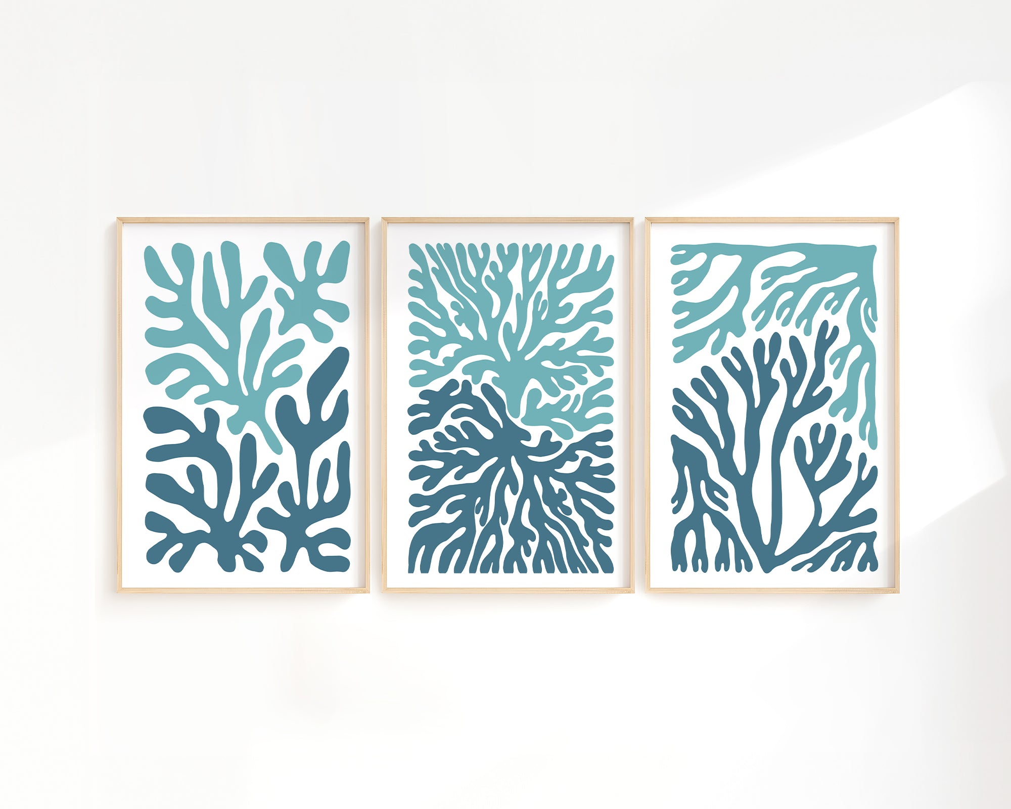 The Ocean Blocks Triptych | Set of Three Prints | 308 features framed abstract art with blue and teal coral-inspired shapes, bringing a modern accent to your home decor.