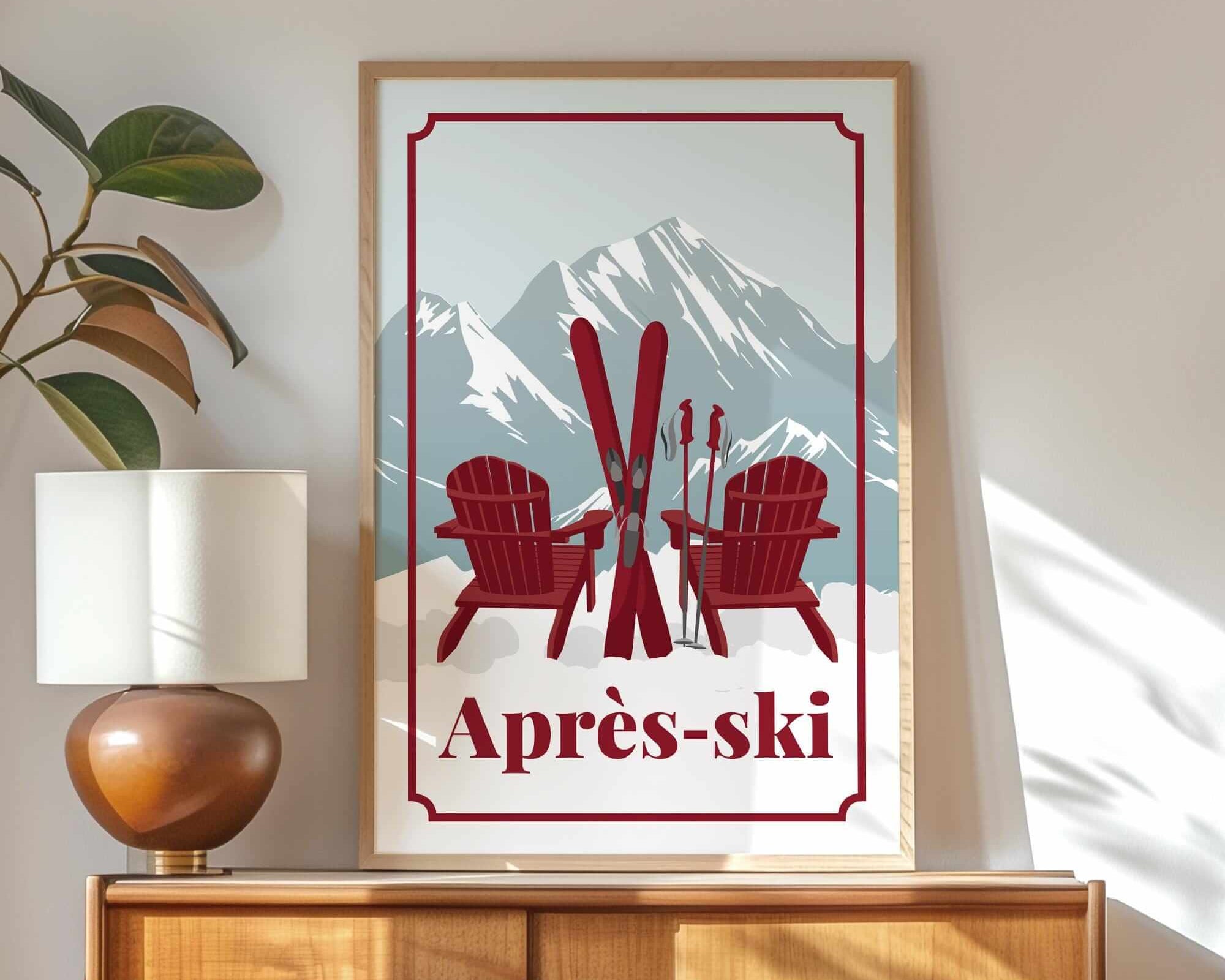 a framed poster of two red Adirondack chairs with skis, set against a mountain backdrop, with the text "Apres-ski" below the poster.