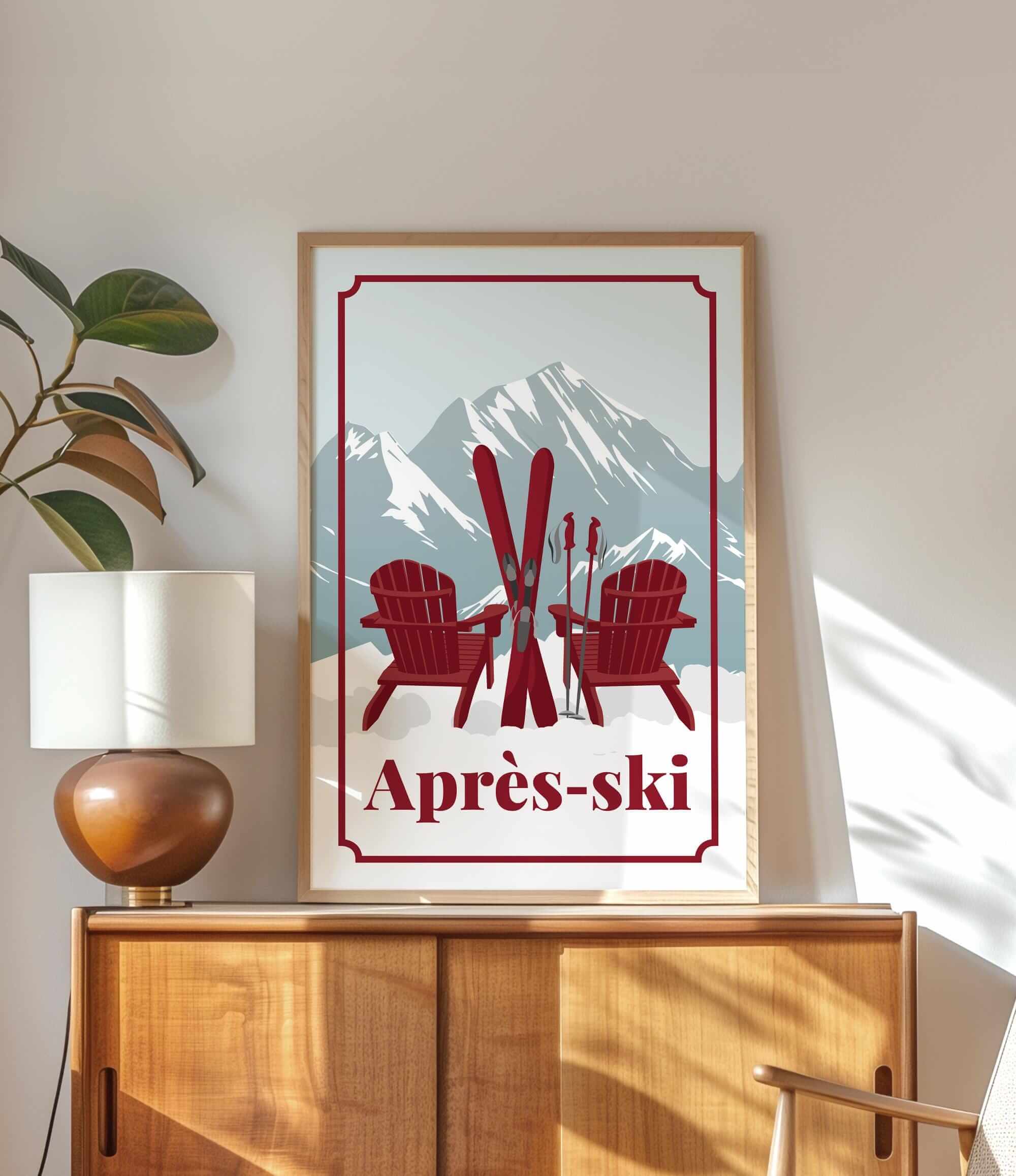 a framed poster of two red Adirondack chairs with skis, set against a mountain backdrop, with the text "Apres-ski" below the poster.
